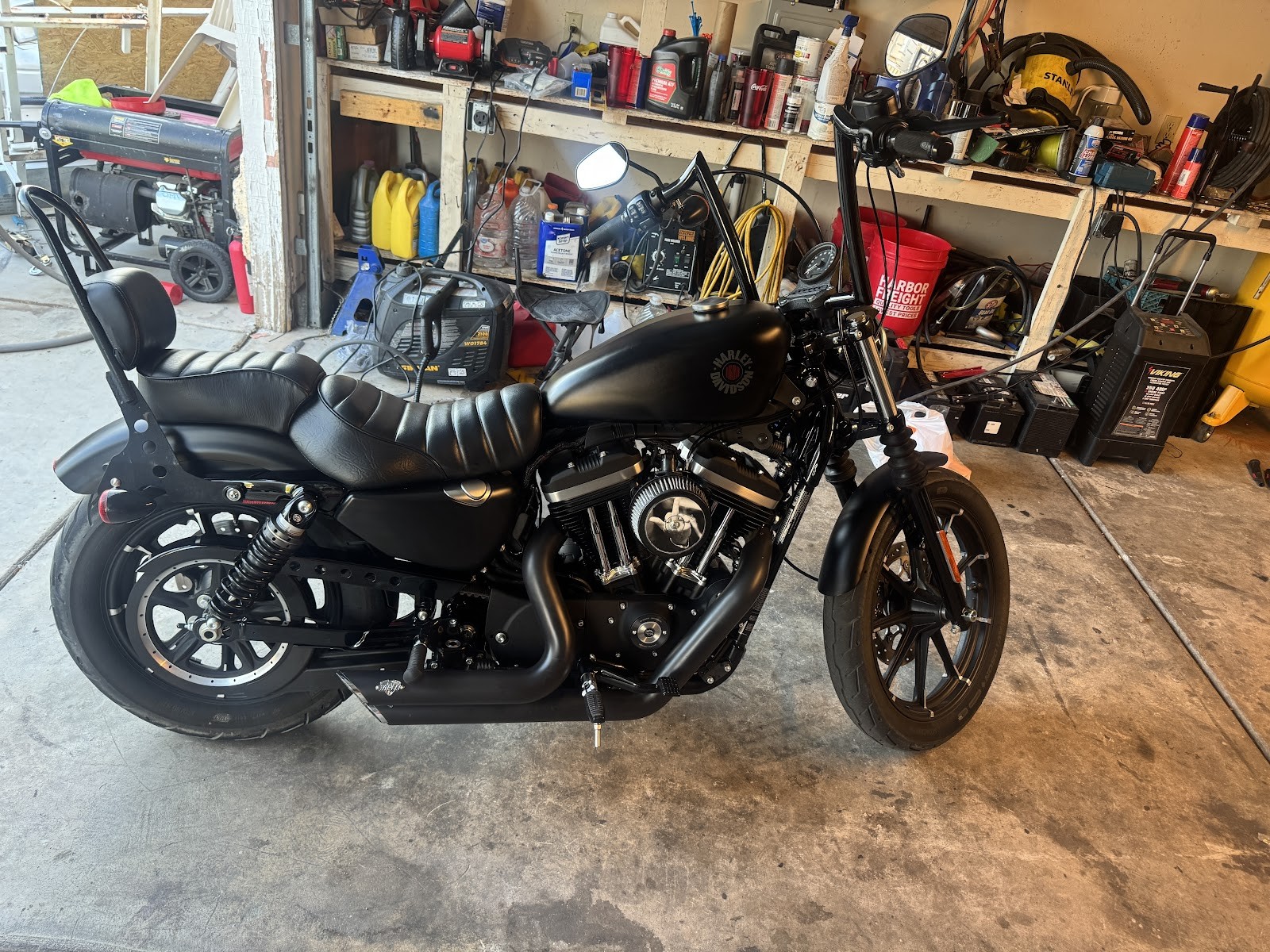 Blacked-out Harley-Davidson Sportster Iron in a garage after service