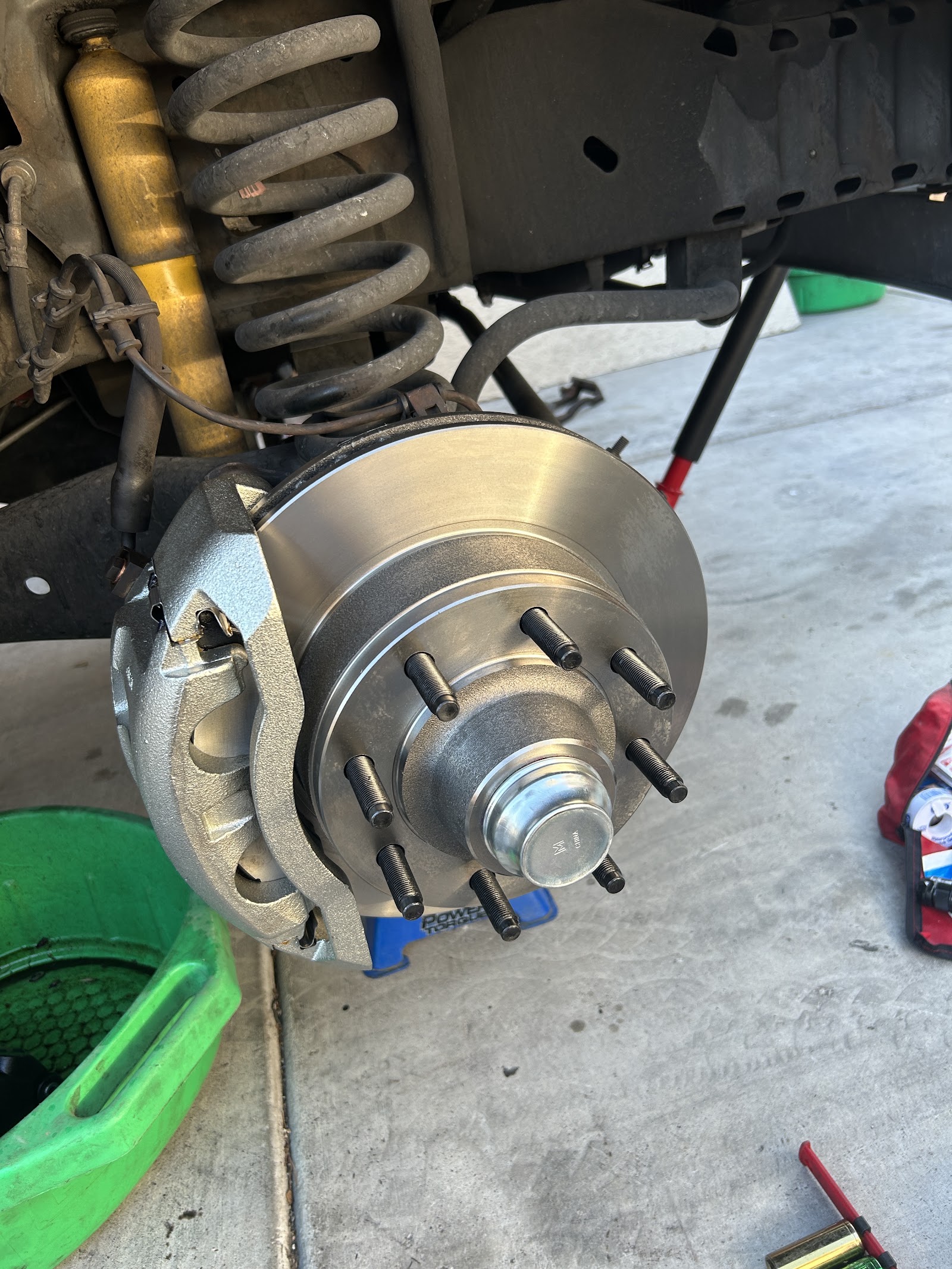 New brake rotor and hub with lug studs on a lifted truck