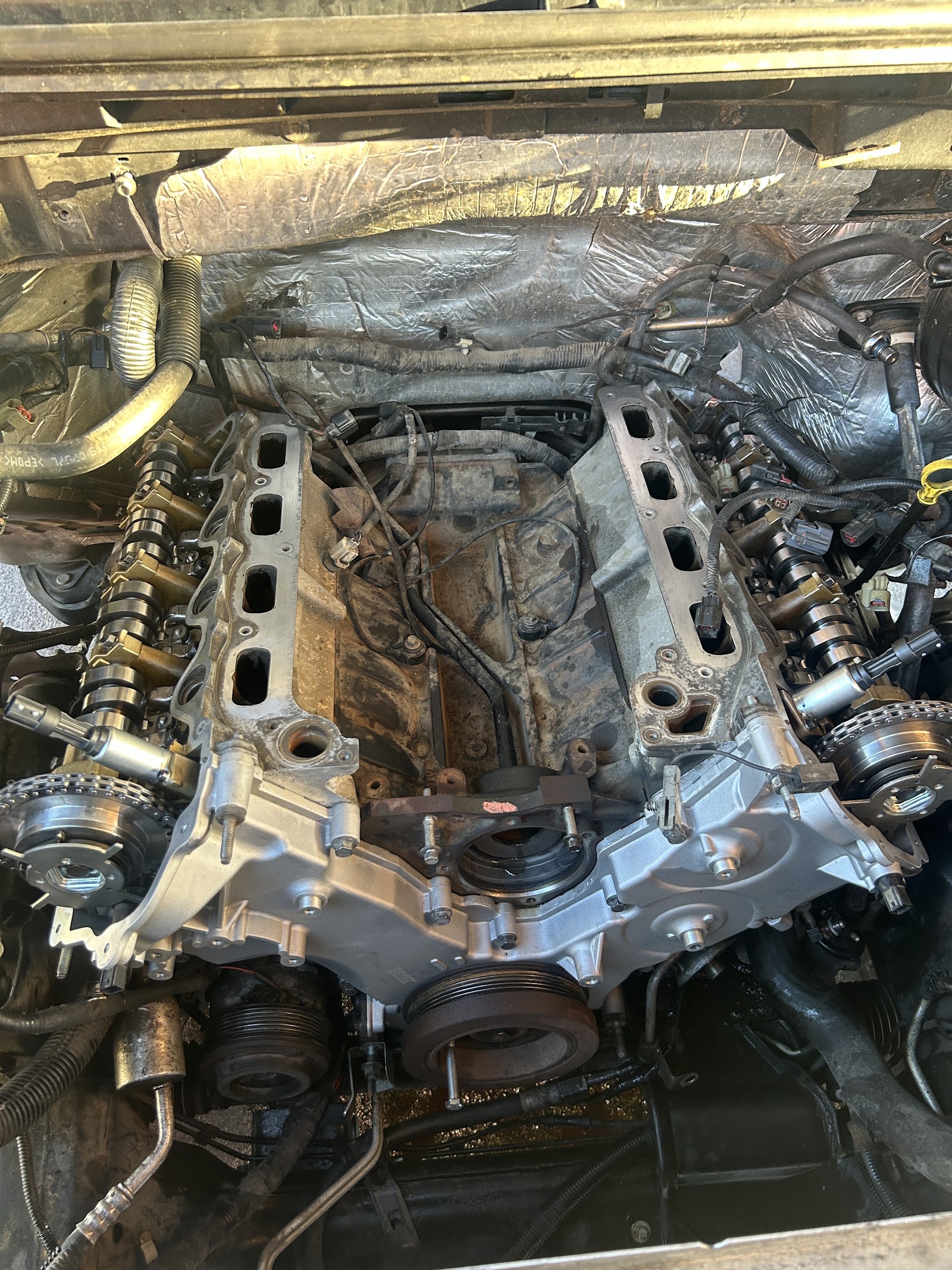 V-engine with intake and valve covers removed mid-repair
